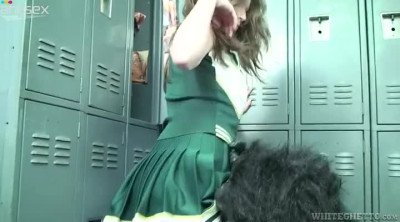Cute cheerleader kicks dude in his balls in a locker room